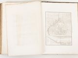 an open book with a drawing of a city on it