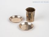 deux plats en argent et une tasse posés sur un plateau blanc