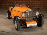 a small orange car parked in a parking lot