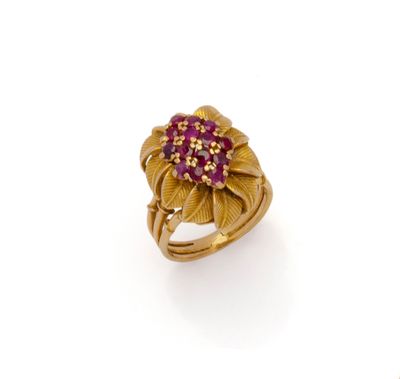 an image of a gold ring with pink stones on it