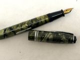 deux stylos à plume posés l'un à côté de l'autre sur une table