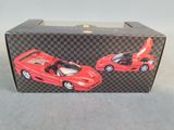 a box with a red toy car and a black toy car