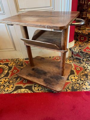 a small wooden table with a shelf on top of it