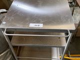 a metal table that is sitting in the middle of a room