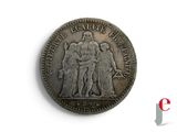 an old coin with a picture of a group of people on it