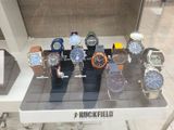a lot of watches on display in a glass case