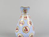 blue and white vase with gold trim and flowers on it