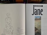 a book with a drawing of a woman sitting on a bench