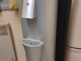 a water dispenser in the corner of a room