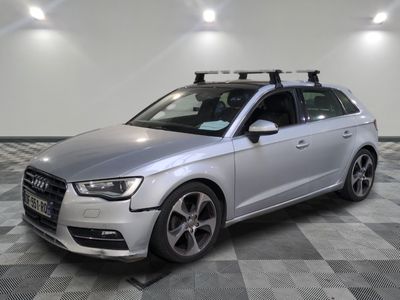 the silver audi is parked on a checkered floor in a garage