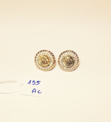 two pairs of gold and diamond earrings on a white surface