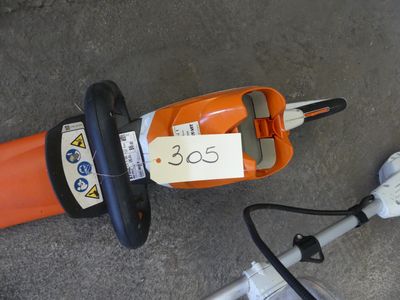 a corded blower sitting on the ground next to a power strip