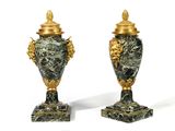 two vases sitting on top of each other on a white surface