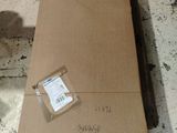 a cardboard box sitting on top of a carton on the floor