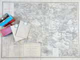 a map on the floor with a bunch of books on it