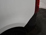a close up of a white truck with a red tail light