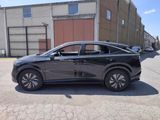 a picture of a black car parked in front of a building