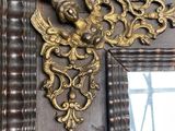 a picture of a mirror with a gold decoration on it