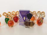 four perfume bottles with a box of perfume sitting on a table