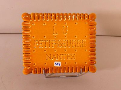 a small orange plaque with a name on it