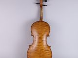 an antique violin with a wooden back and a wooden bow