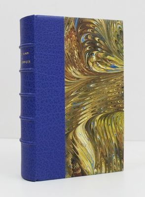 a blue book with a gold and blue cover sitting on a table