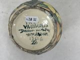 a vase with a label on it sitting on a table