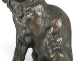 bronze statue of a dog sitting on its hind legs