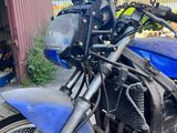 a blue motorcycle parked in front of a red building