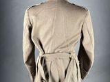 the back view of a beige jacket with a belt on a mannequin mannequin mannequin mannequin mannequin mannequin manne