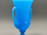an image of a blue glass vase sitting on top of a table