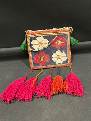 une image représentant un sac à main dont pendent des pompons