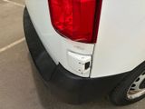 the rear end of a white truck with a red tail light