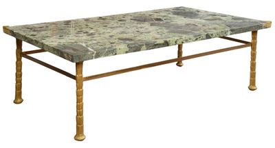 a marble top table with brass legs on a white background
