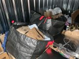 two bags of garbage sitting on a table in a room