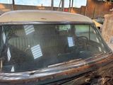 an old car that has been rusted and is sitting in a garage