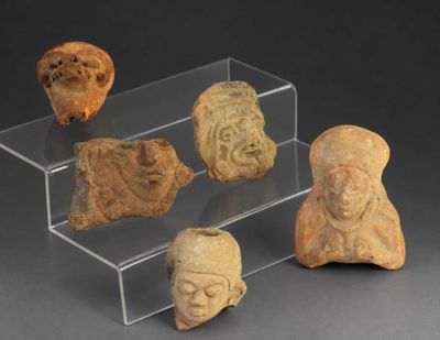 several pieces of pottery are displayed on a clear display case
