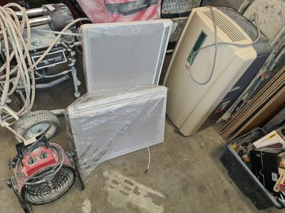 a pile of old appliances and other items in a garage