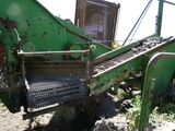 une machine verte qui est à l'arrêt dans la boue