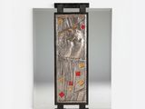 an image of a metal plaque with a picture of a woman on it