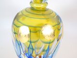 a glass vase with a blue and yellow design on it