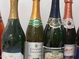 several bottles of wine are lined up on a white surface