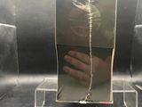 a hand that is holding a mirror on a stand