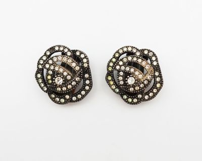 a pair of black and white diamond earrings