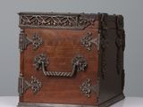 an old wooden chest with ornate carvings and handles on a white surface
