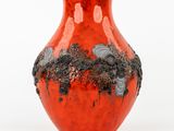 a red vase with black flowers on it on a white background