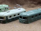 several toy trains are lined up next to each other on the ground