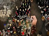 a large amount of bottles of alcohol on the floor