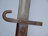 a close up of a knife on a wooden pole
