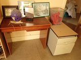 a desk with a computer on top of it in a room